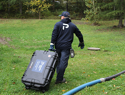 Premier Tech technician with a toolkit to remove excessive sludge from septic systems. 