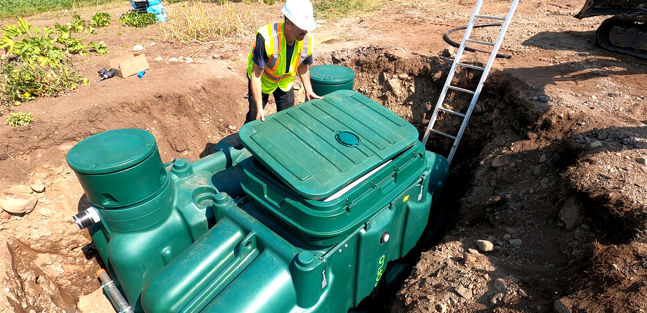 Wastewater professional installing the Ecoflo biofilter Pack on a rural property in Québec, Canada.