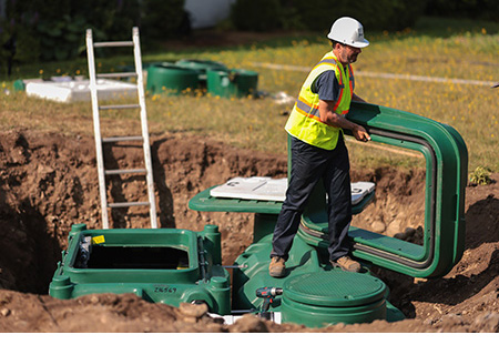 Septic installer demonstrating expertise in the field, one of the biggest advantages of hiring a professional.