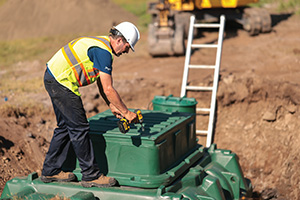 Septic contractor in Ontario closing the main access of a polyethylene Ecoflo compact biofilter.