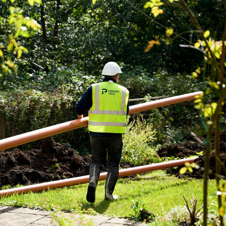 Installation of septic system inlet and outlet pipes.