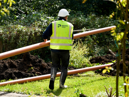 Installation of septic system inlet and outlet pipes.