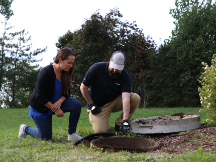 Premier Tech technician explaining recommendations for septic tank repairs.