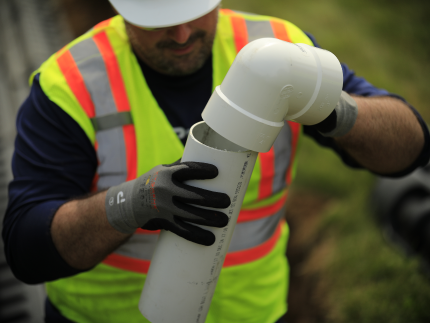 Premier Tech technician repairing a septic line joint.