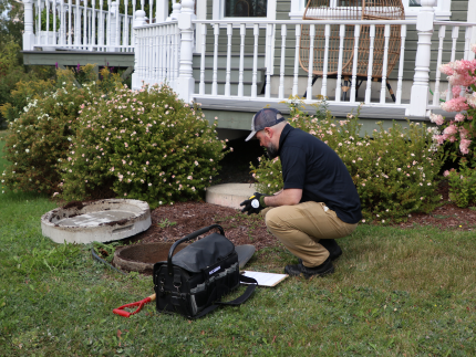 Premier Tech technician inspecting an aging septic tank.
