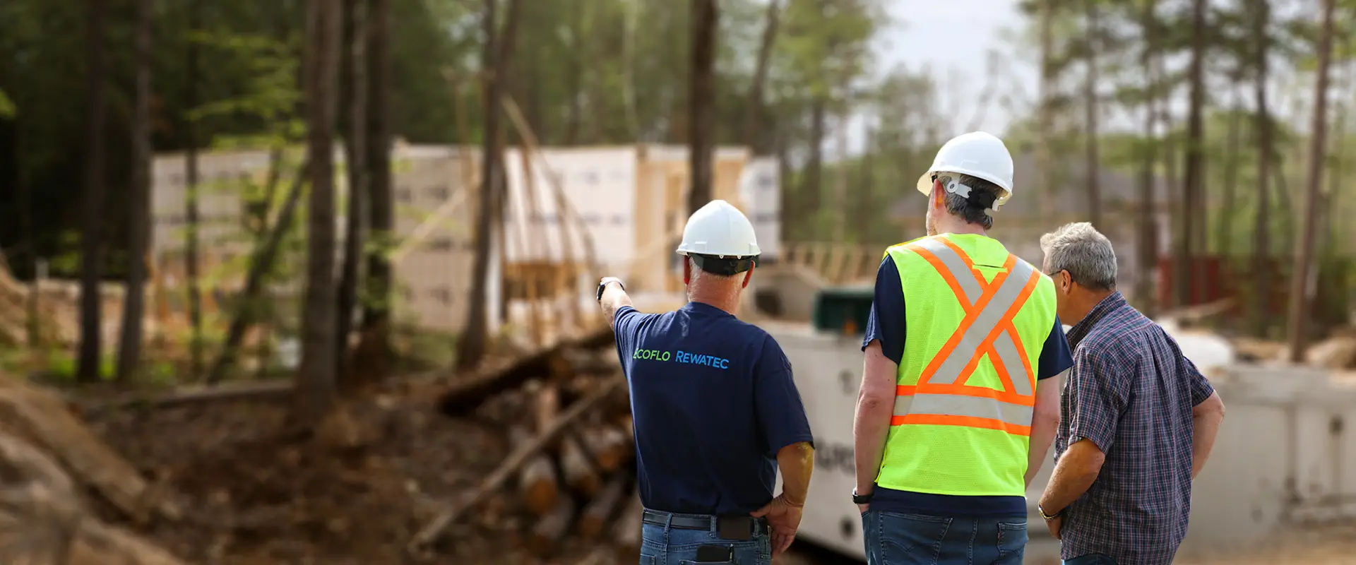 Homeowner with professionals from Premier Tech Water and Environment in front of a septic system in Ontario.