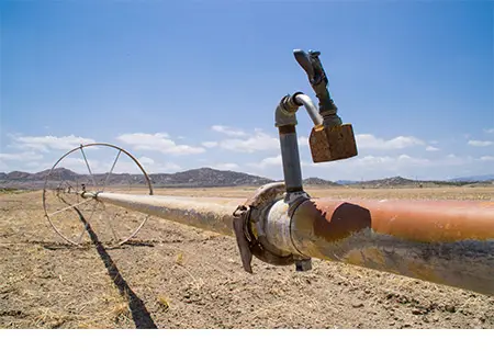 Water irrigation pipes on dry farmland in southern California.