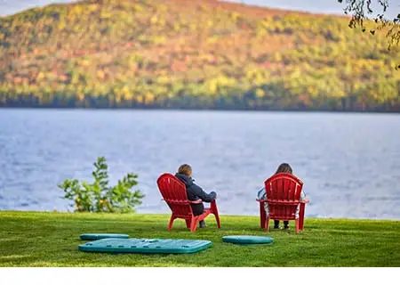 Septic system installed on a small cottage lot and property owners relaxing beside a beautiful lake in Quebec, Canada.
