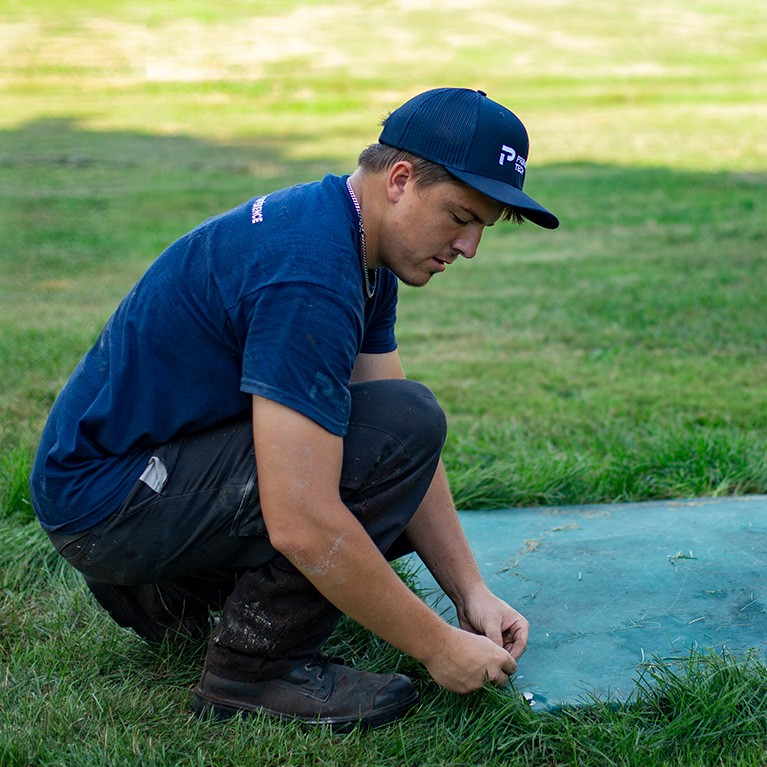 Technician performing annual maintenance on an Ecoflo septic system.
