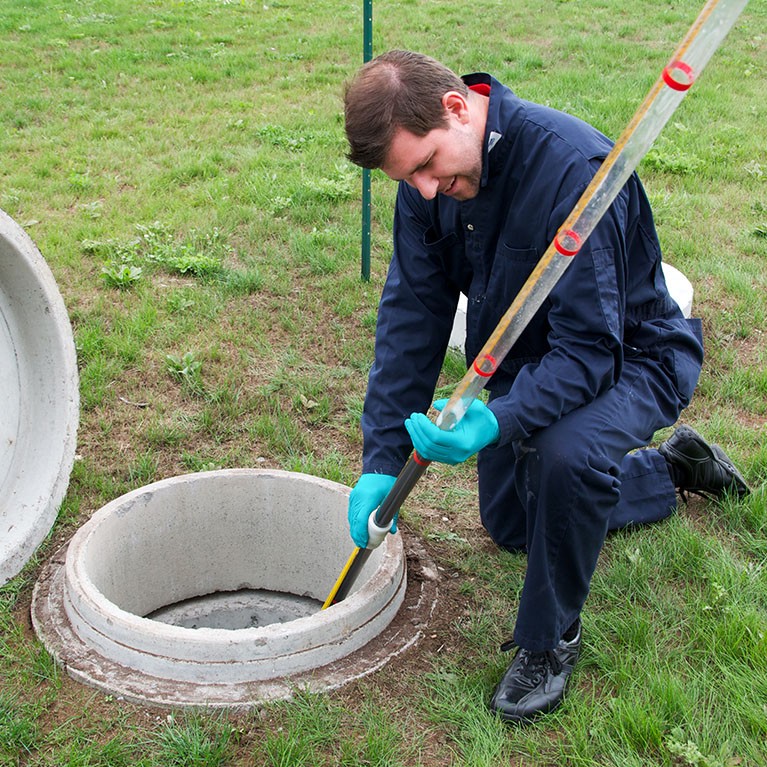 Technician performing a test in a sewage treatment plant