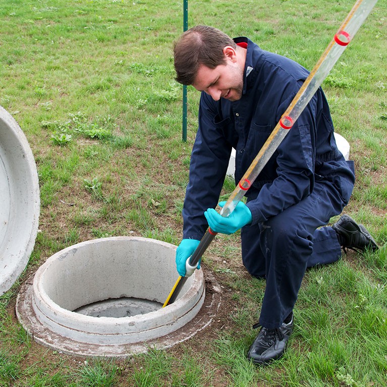 Technician performing a test in a sewage treatment plant