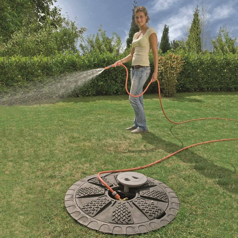 Women using harvested rainwater for watering the garden