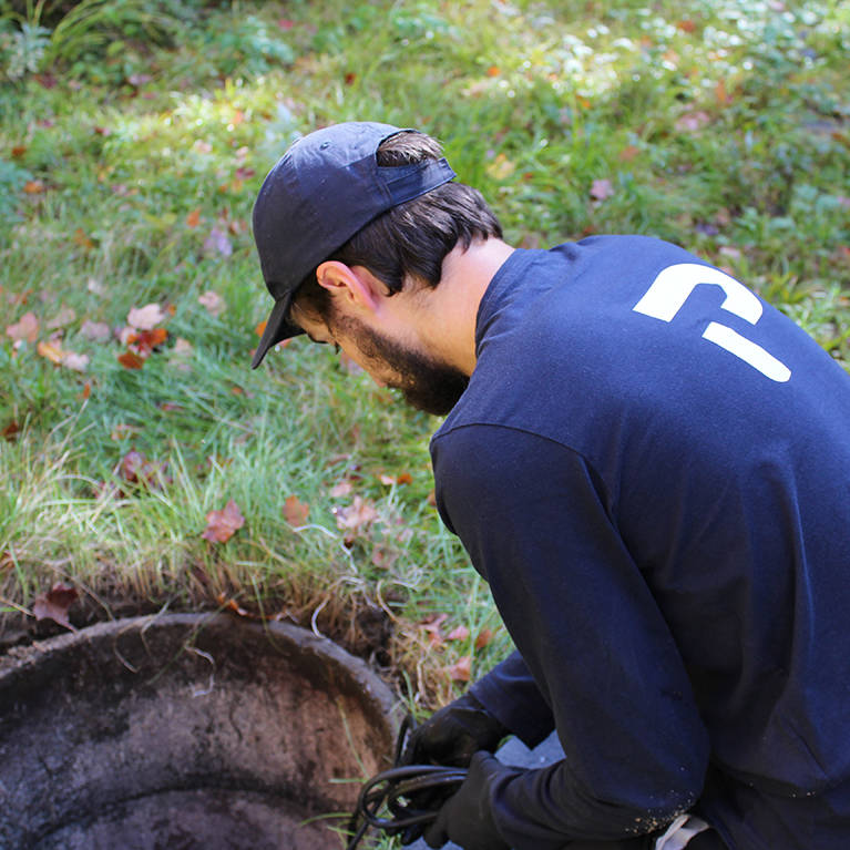 Premier Tech technician performing maintenance on a failing Bionest septic system.