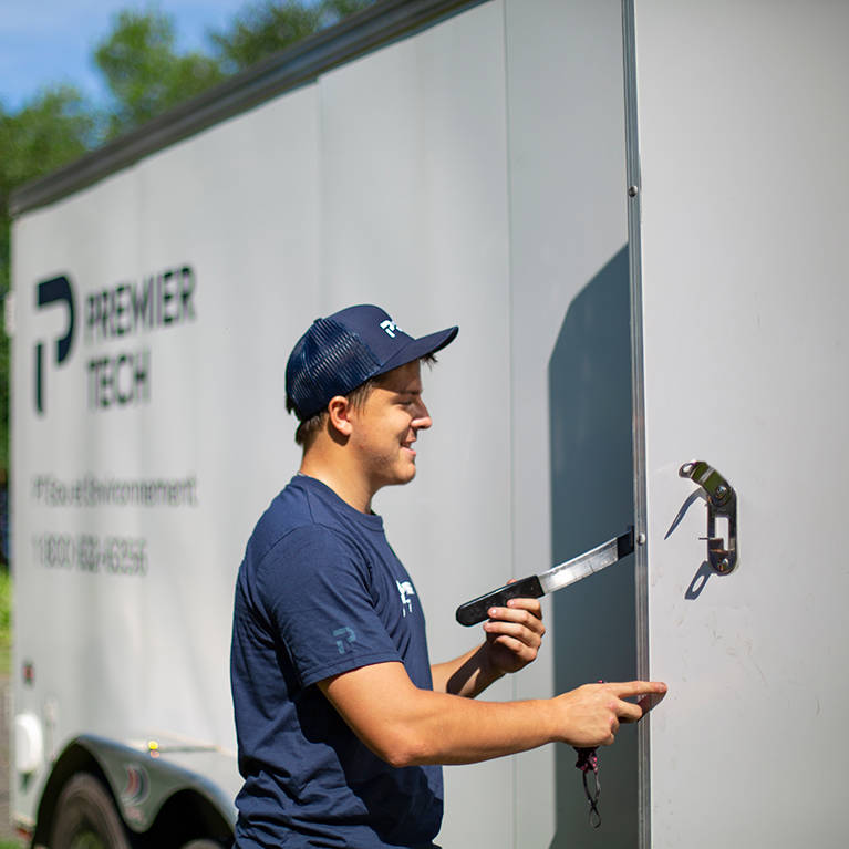 Premier Tech technician performing an annual maintenance of a septic system.