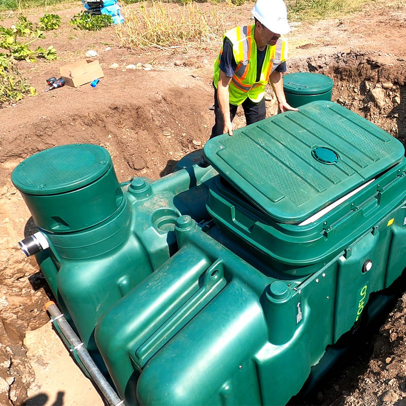 Septic contractor installing the Pack model of the Ecoflo compact biofilter on a residential property.