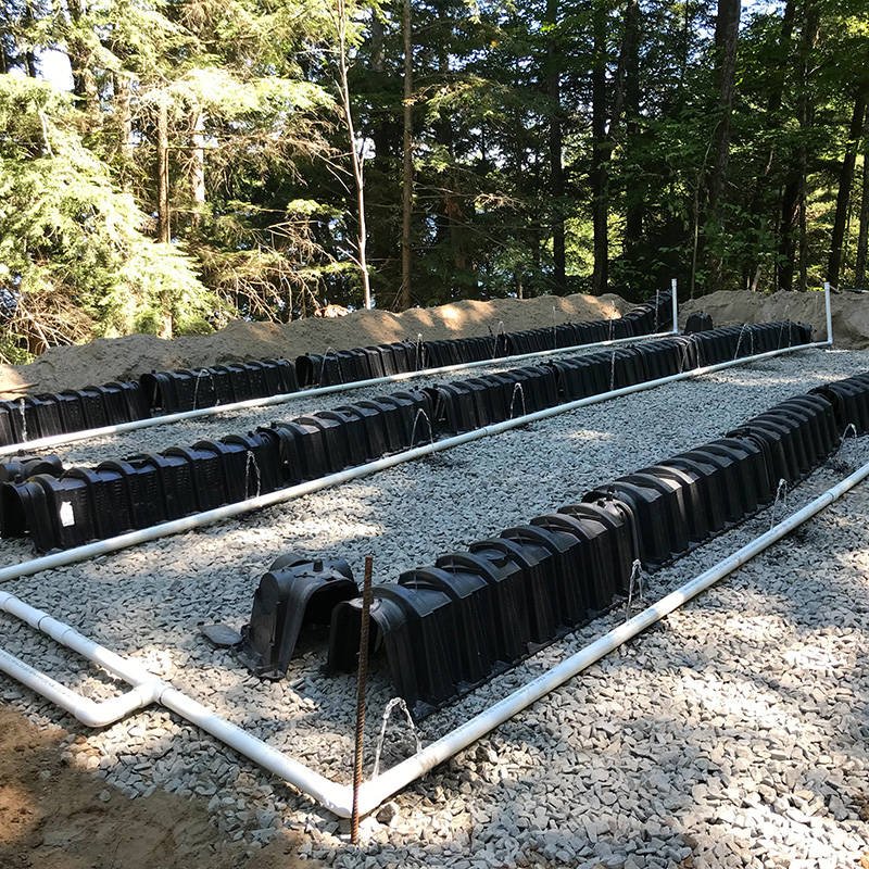 Shallow buried trench septic drain field paired with the Ecoflo compact biofilter advanced secondary treatment system.