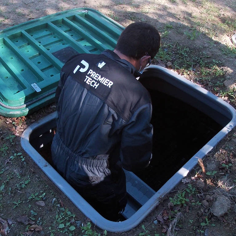 Premier Tech Water and Environment technician performing maintenance on a commercial sewage treatment plant in the UK.