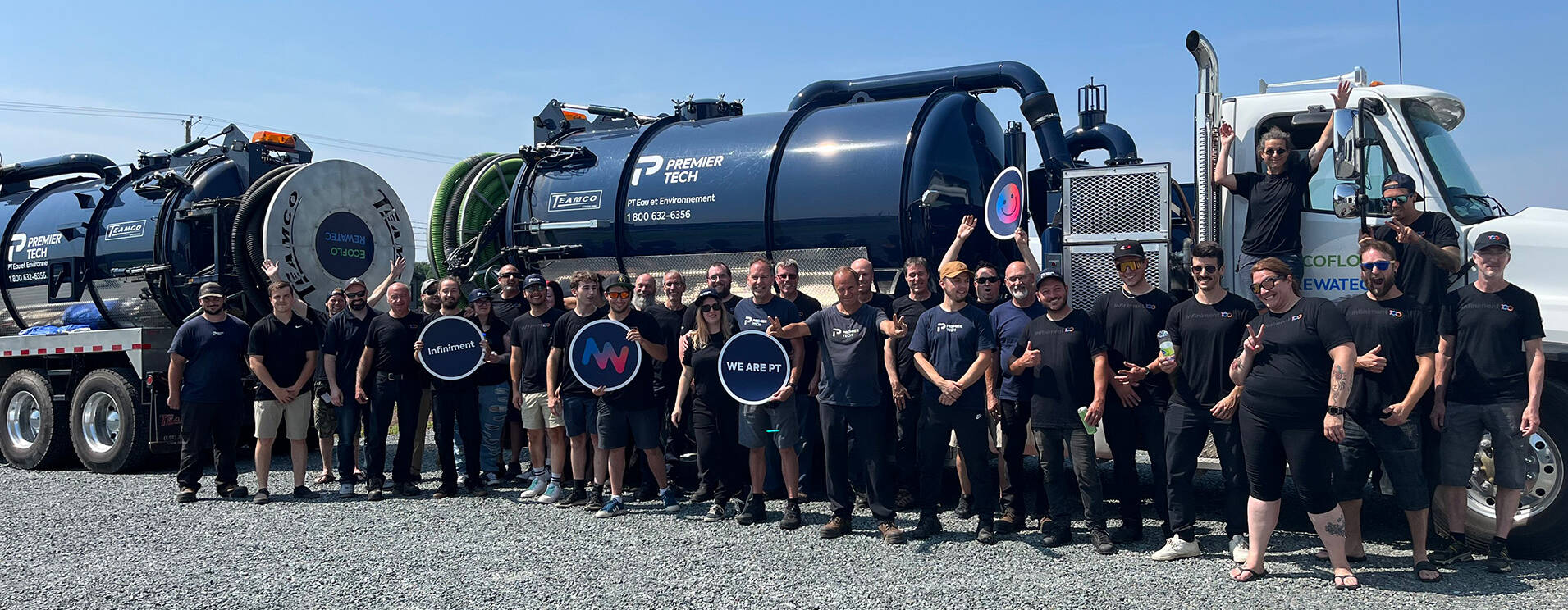 Premier Tech Water and Environment team members in front of two septic pumping trucks in Pennsylvania.