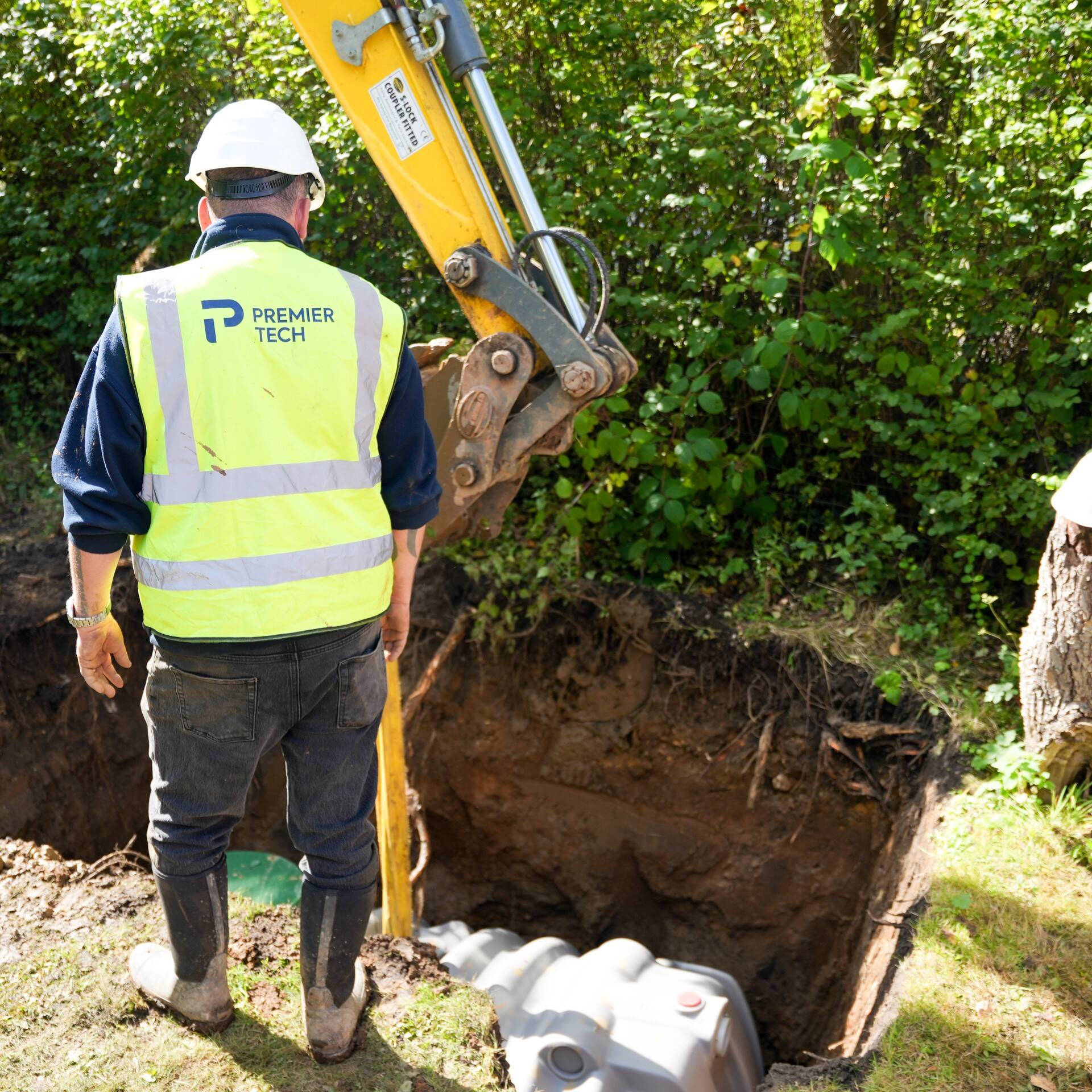 Premier Tech technician installing a septic tank in the UK.