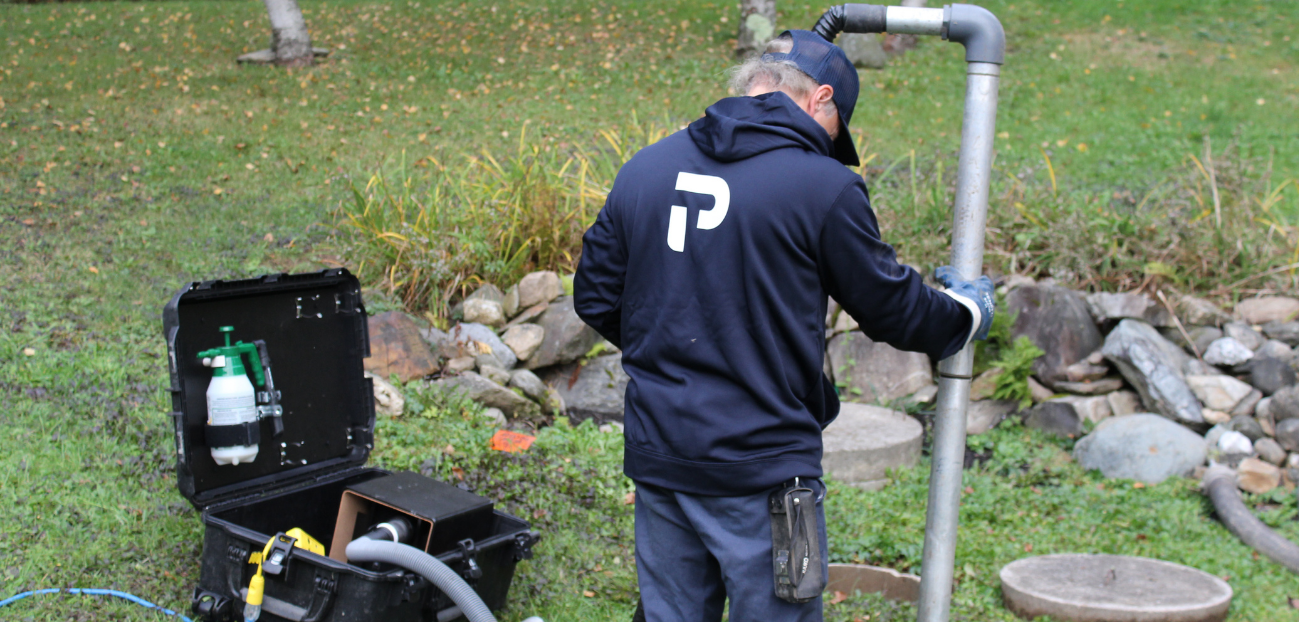 Premier Tech technician removing sludge from a failing Bionest-type septic system.