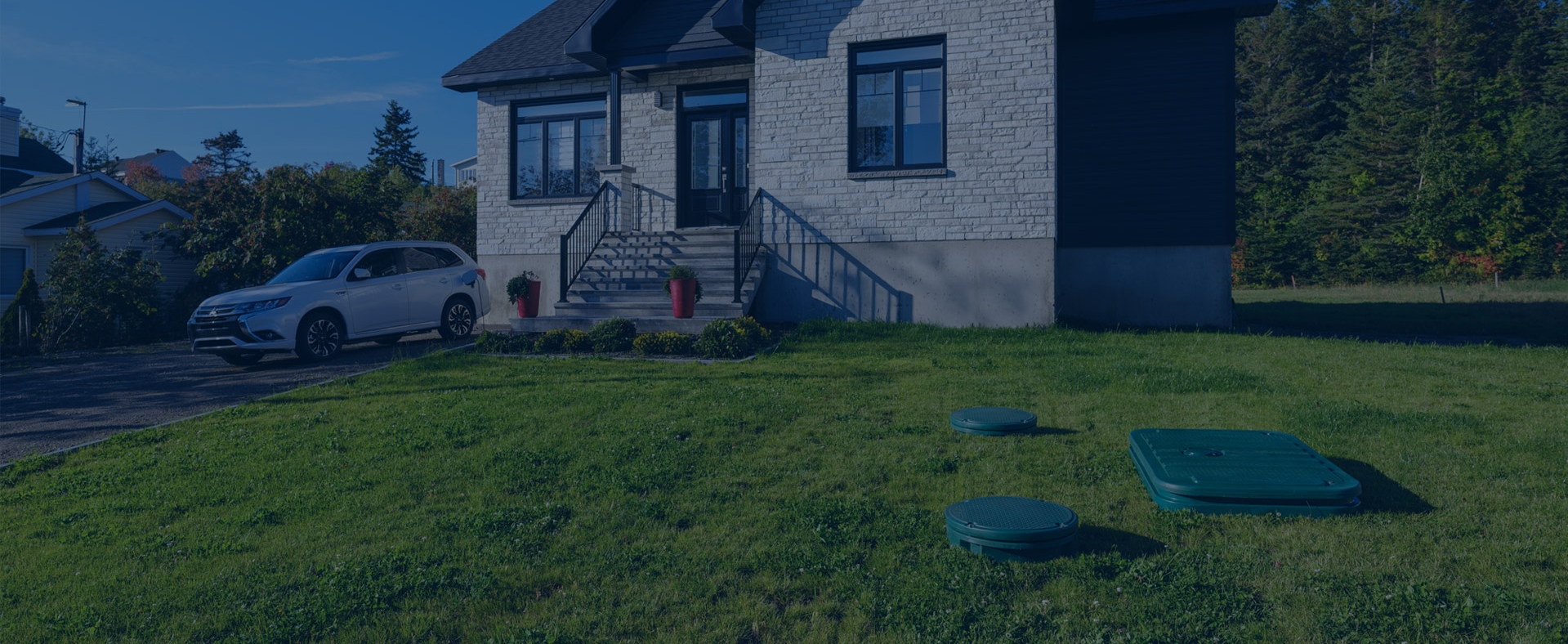 A residential property with a septic system installed in the front yard.