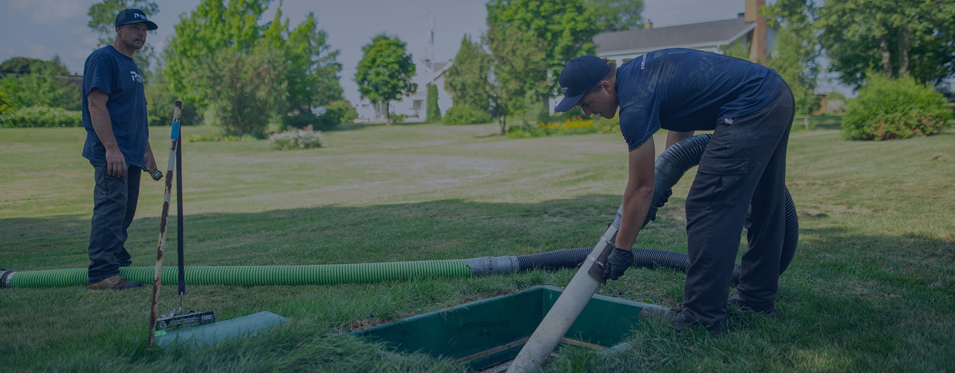 Premier Tech Water and Environment partners performing service on the Ecoflo biofilter septic system on a residential property.