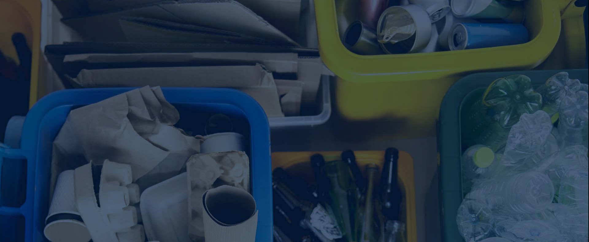 Paper, plastic, glass, and aluminium separated into bins for solid waste recycling.