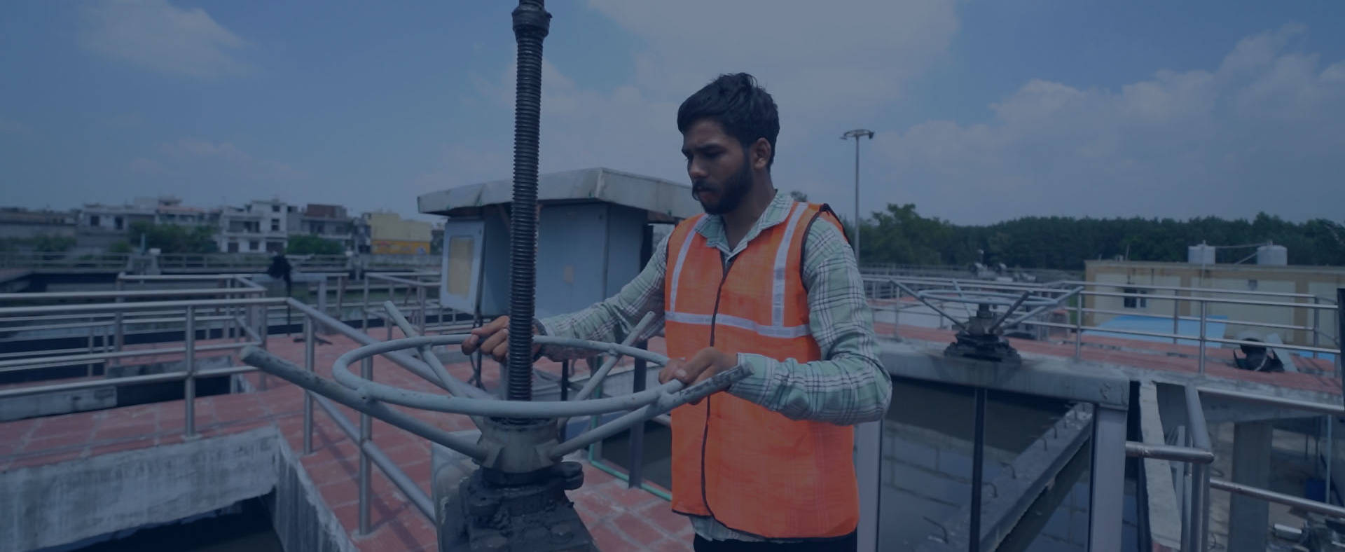 Premier Tech Water and Environment technician performing operations tasks at an SBR wastewater treatment plant in India.