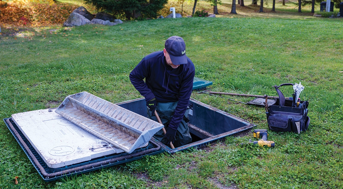 Premier Tech's local service technician maintaining an Ecoflo biofilter septic system.