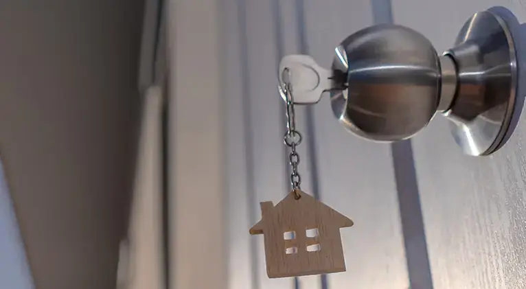 Key in the lock of a recently sold home.