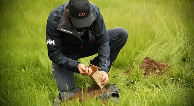 Premier Tech technician testing soil for a septic system installation.