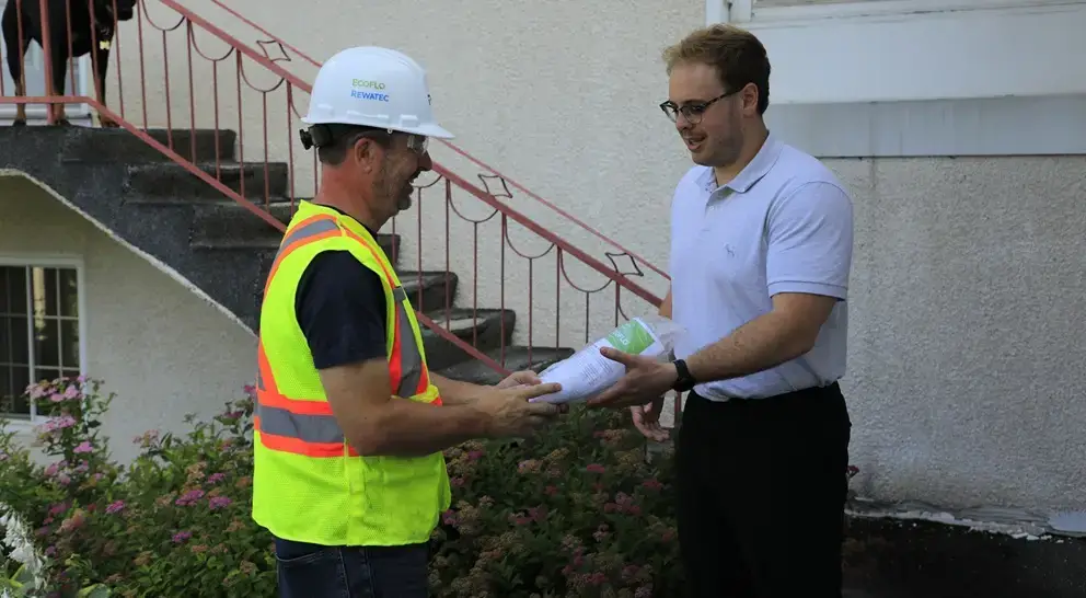 Client receiving the owner's manual for the Ecoflo compact biofilter.