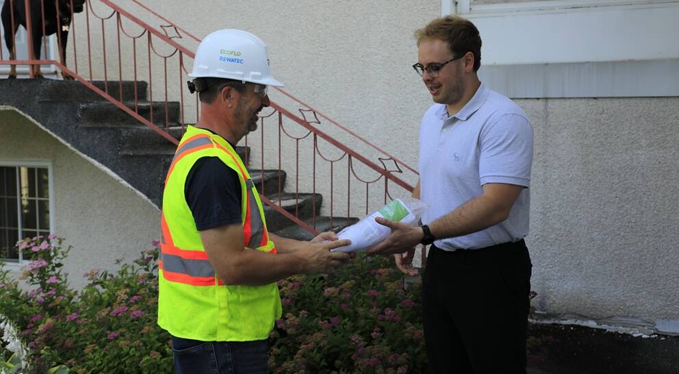 Client receiving the owner's manual for the Ecoflo compact biofilter.
