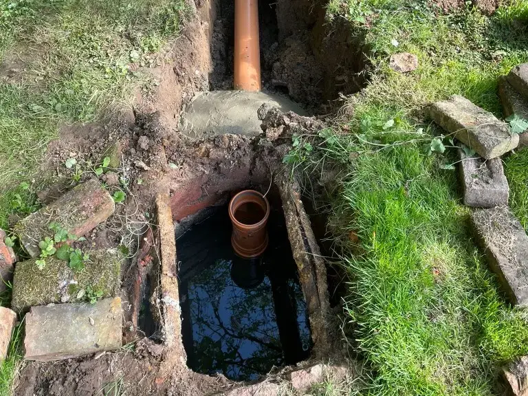 Non-compliant septic tank with piping to a drainage field.