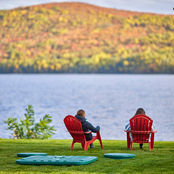 Homeowners sitting between a lake in Québec, Canada, and the Ecoflo compact biofilter septic system.
