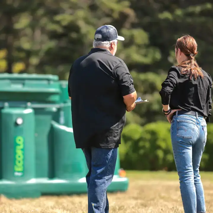 Homeowner speaking with a Premier Tech expert about the Ecoflo biofilter.