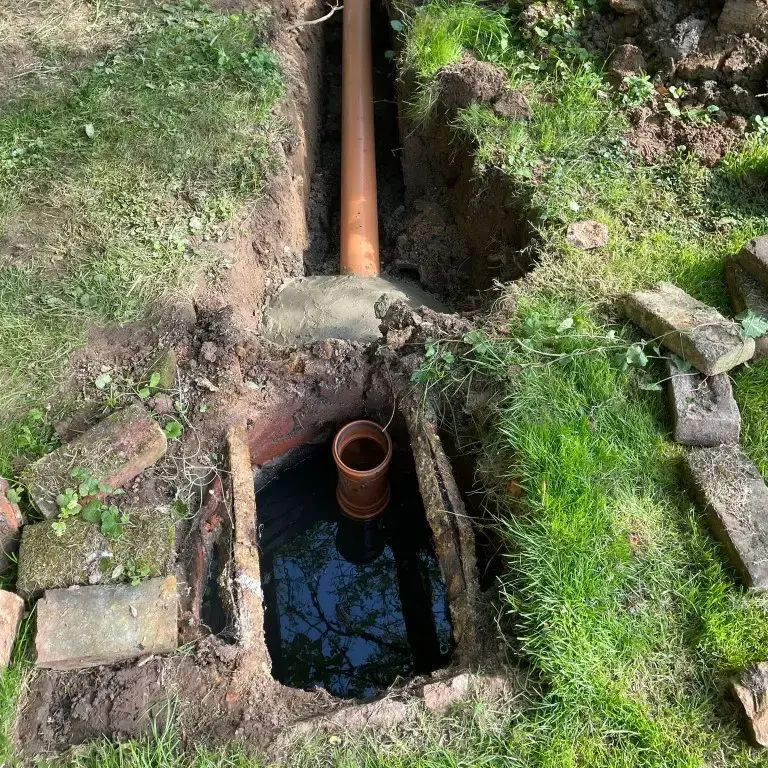 Non-compliant septic tank with piping to a drainage field.