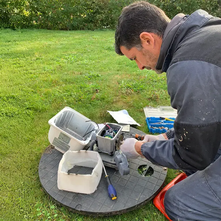 Premier Tech technician repairing a septic aerator in the UK.