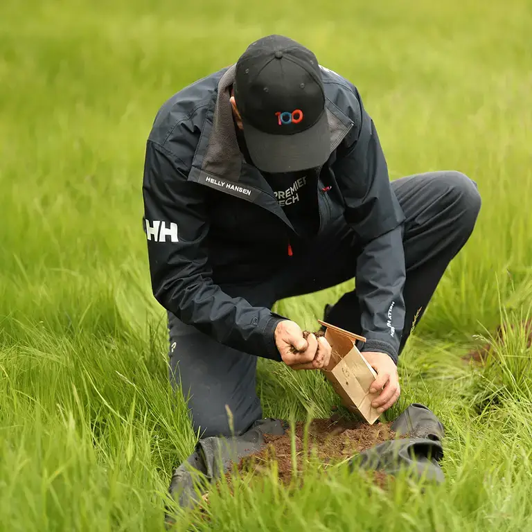 Premier Tech technician testing soil for a septic system installation.