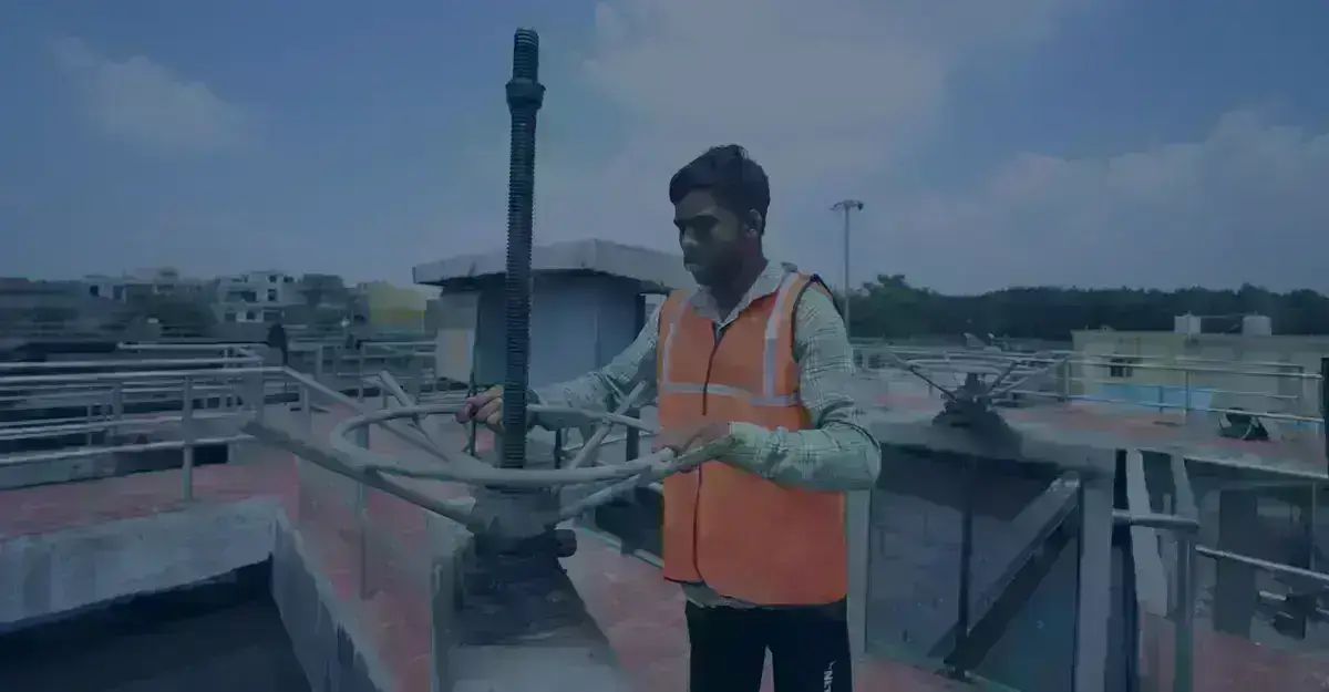 Premier Tech Water and Environment technician performing operations tasks at an SBR wastewater treatment plant in India.
