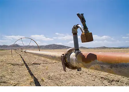 Water irrigation pipes on dry farmland in southern California.