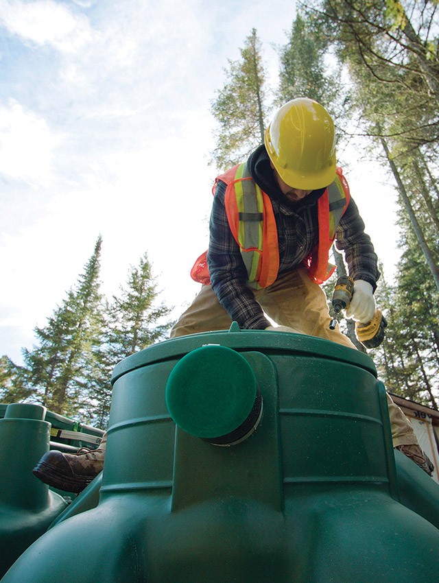 Wastewater treatment professional installing the polyethylene Pack model of the Ecoflo biofilter septic system.