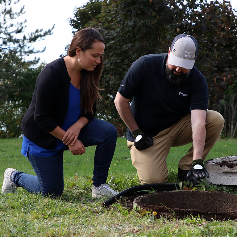 Premier Tech Water and Environment service technician performing a survey of a residential septic tank in the UK.