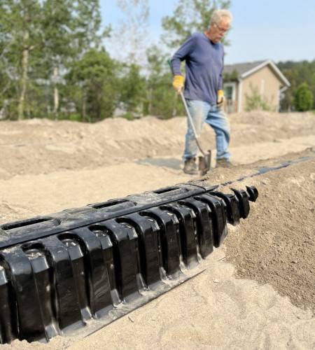 Septic installer on a residential site with the Ecoflo linear biofilter.