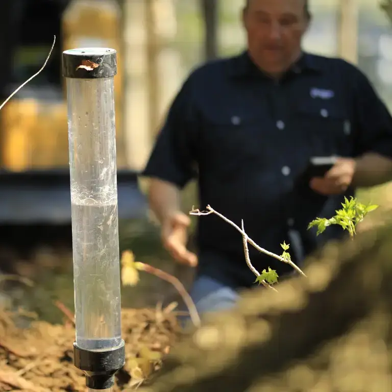 Premier Tech technician performing a soil percolation test.